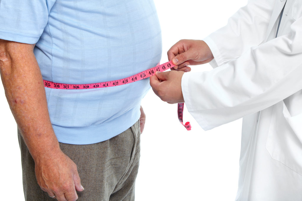 Doctor measuring obese man's waist