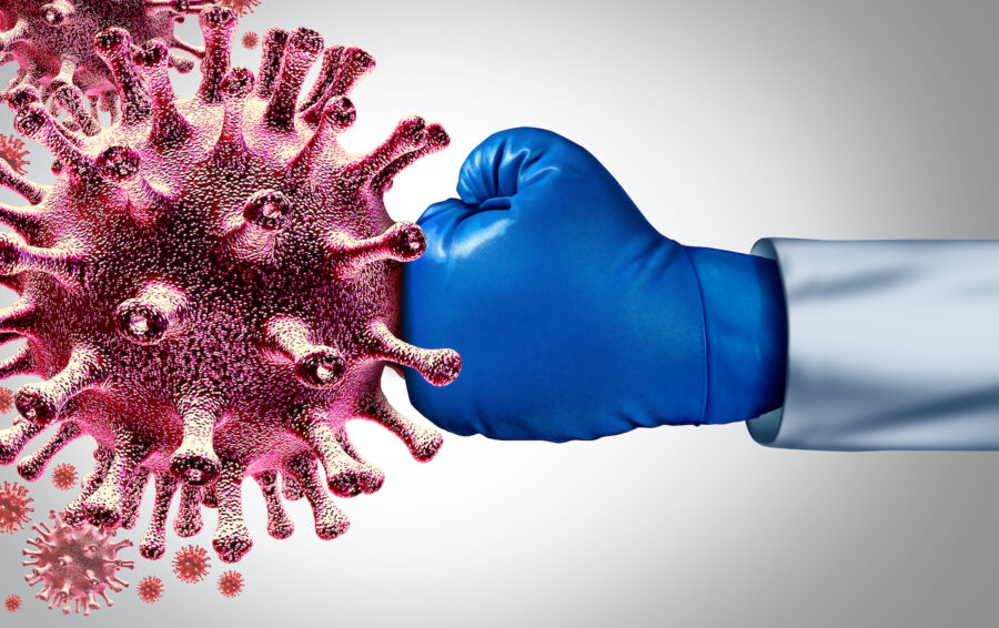 Hand in blue boxing glove hits and destroys Covid virus