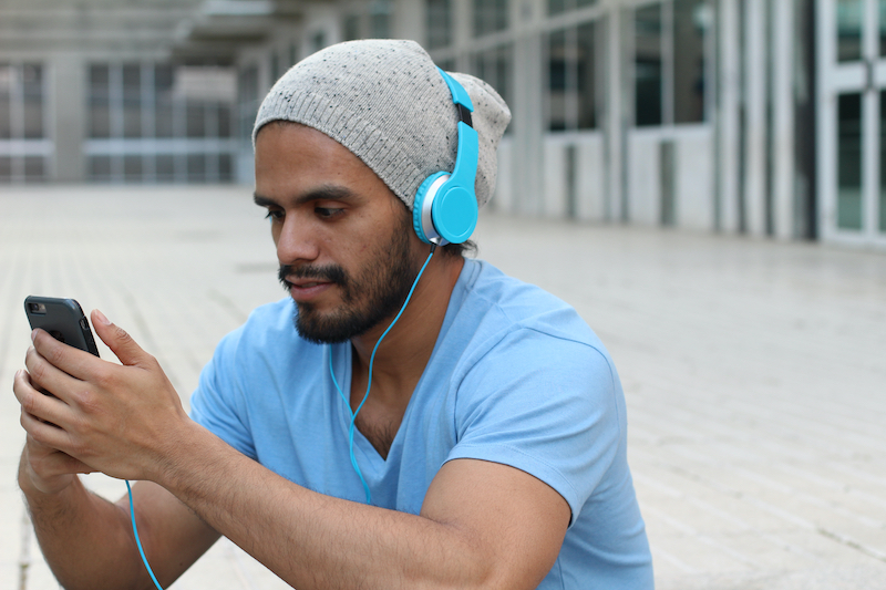 Man wearing headphones and learning about Free English Lessons for Pashto Speakers