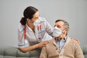 Doctor and senior man wearing medical masks