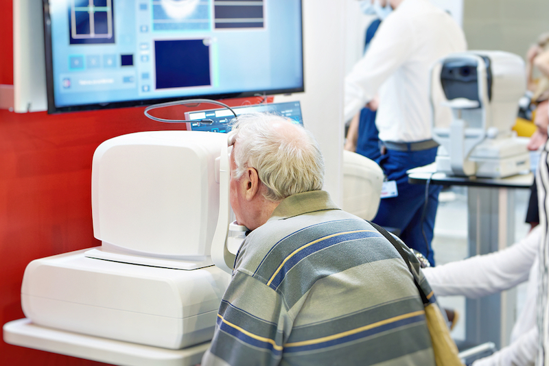 Doctor and patient with ophthalmic spectral optical coherent tomograph and monitor