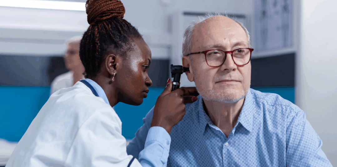 Older man receiving hearing exam by doctor