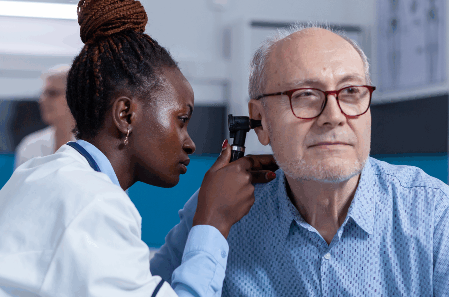 Older man receiving hearing exam by doctor