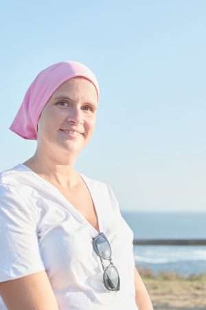 Woman with breast cancer wearing a pink headscarf